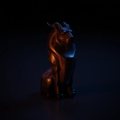 Lion statue with intricate design and horns.
cerry wood sculpture, shiny wood