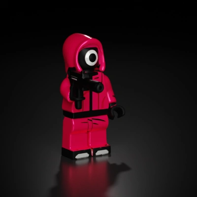 Pink hooded toy figure with weapon.
