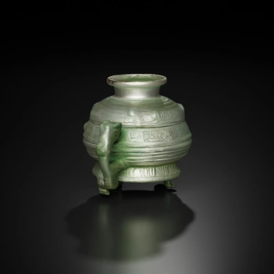 Ancient ceremonial tripod vessel, ornate engravings.