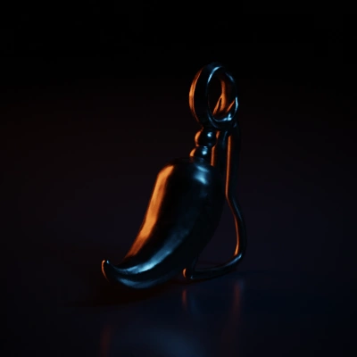 Small horn pendant, metallic surface, with a ring loop.