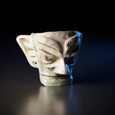 Ancient stone face sculpture with prominent features.