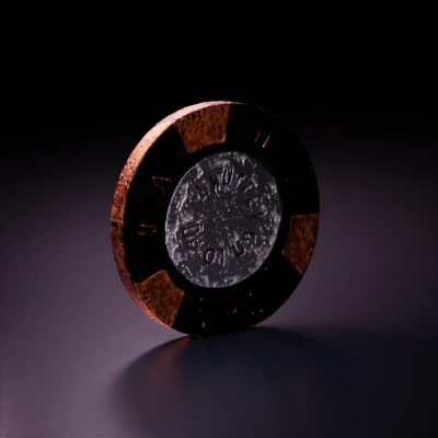 Token-like metallic object with inscriptions.
