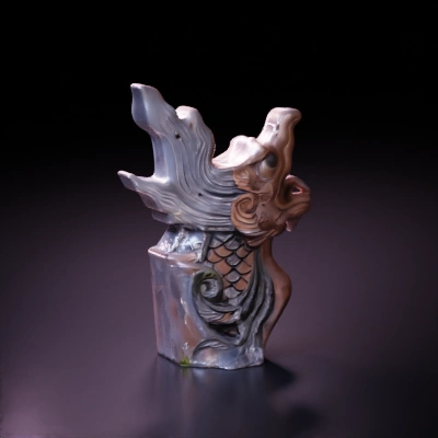 Ornamental fish-dragon sculpture, intricate carving.
