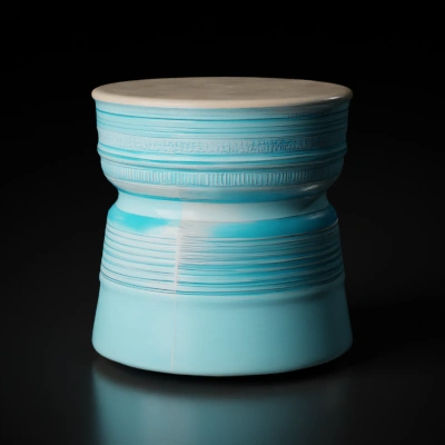 Ceramic decorative stool with textured surface.