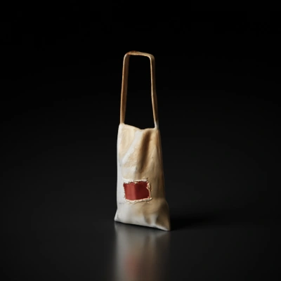 Worn-out fabric shoulder bag with visible patch.