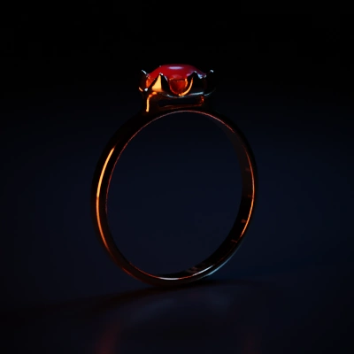 Golden ring with large red gemstone.