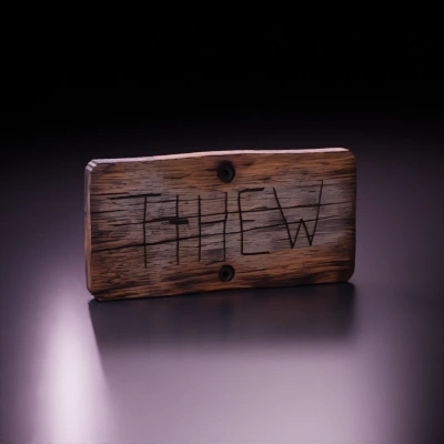 wooden sign with engraved text.