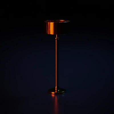 Tall floor lamp with cylindrical brass shade.