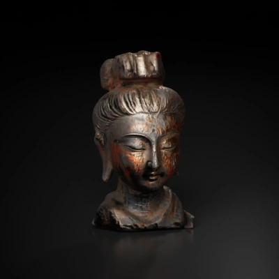 Ancient Buddha head sculpture, serene expression.